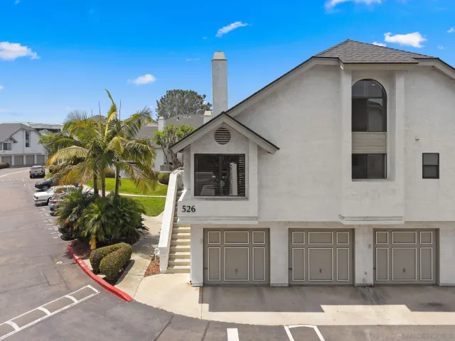 a view of a house with a balcony and potted plants