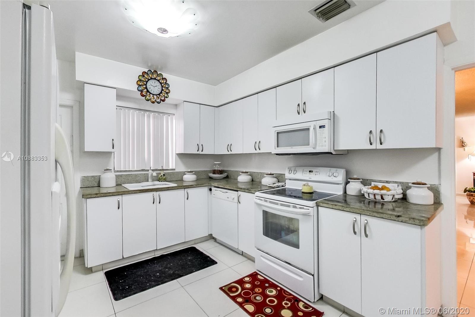 63 Southwest 31st Road Miami, FL 33129 - Photo 15 of 34 a kitchen with stainless steel appliances granite countertop a sink and cabinets