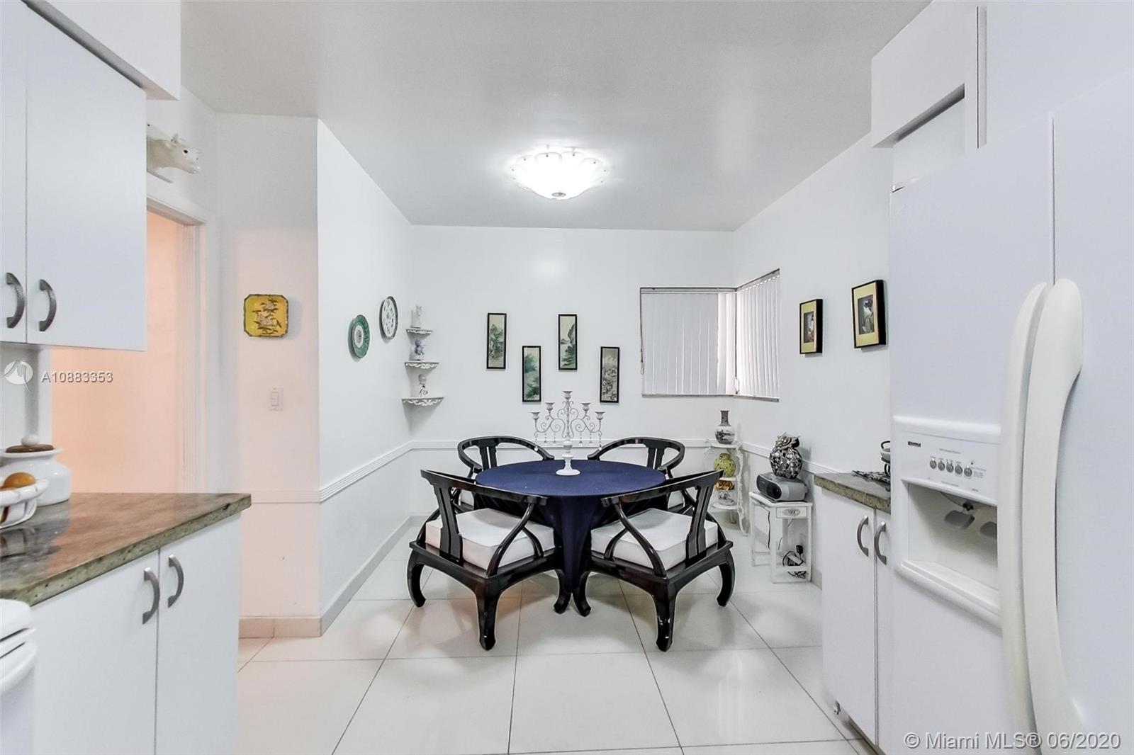 63 Southwest 31st Road Miami, FL 33129 - Photo 16 of 34 a view of a kitchen with dining area a sink and a refrigerator