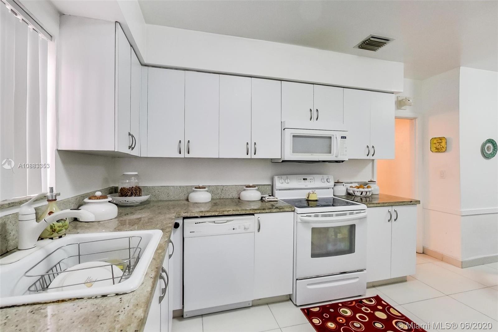 63 Southwest 31st Road Miami, FL 33129 - Photo 17 of 34 a kitchen with stainless steel appliances granite countertop a sink stove and refrigerator