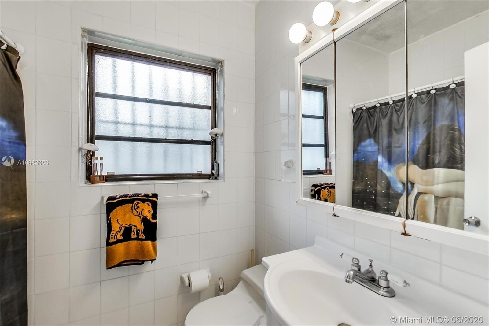 63 Southwest 31st Road Miami, FL 33129 - Photo 20 of 34 a bathroom with a sink and a mirror