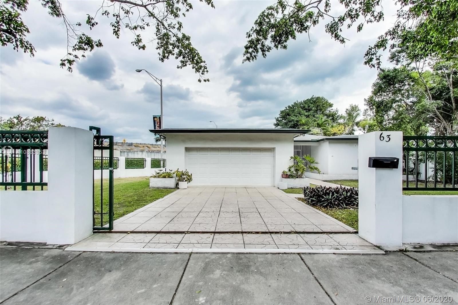 63 Southwest 31st Road Miami, FL 33129 - Photo 3 of 34 a front view of a house with a garage