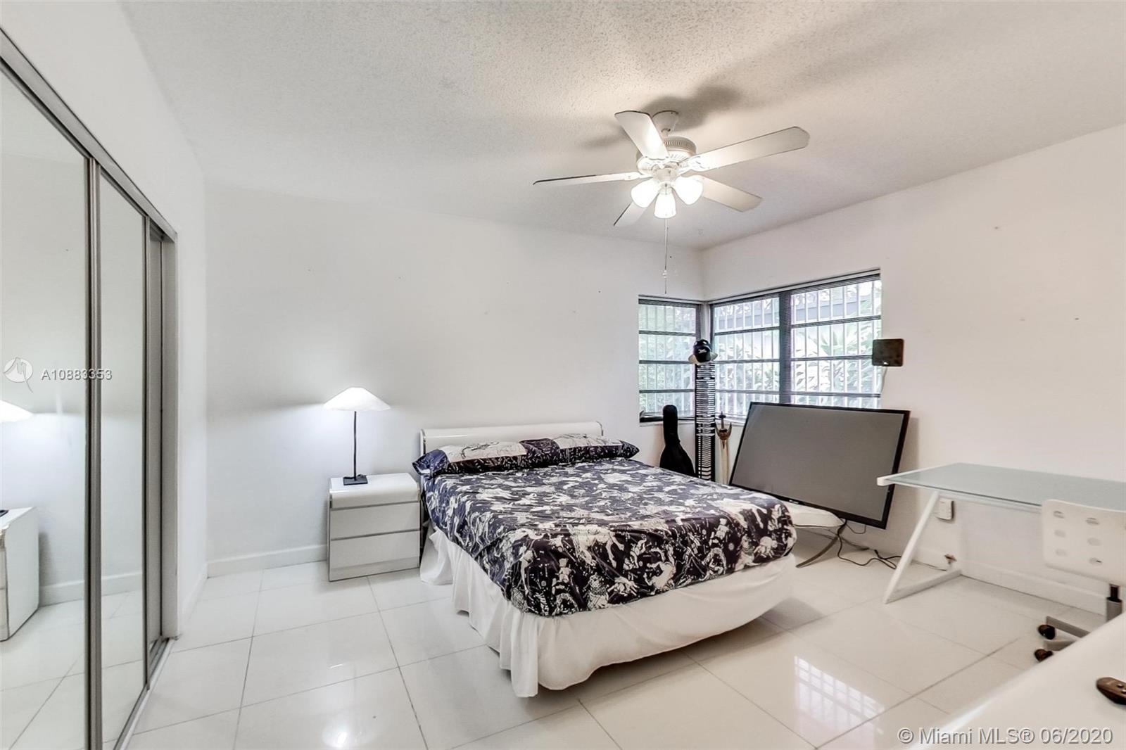 63 Southwest 31st Road Miami, FL 33129 - Photo 21 of 34 a bedroom with a bed and a chandelier