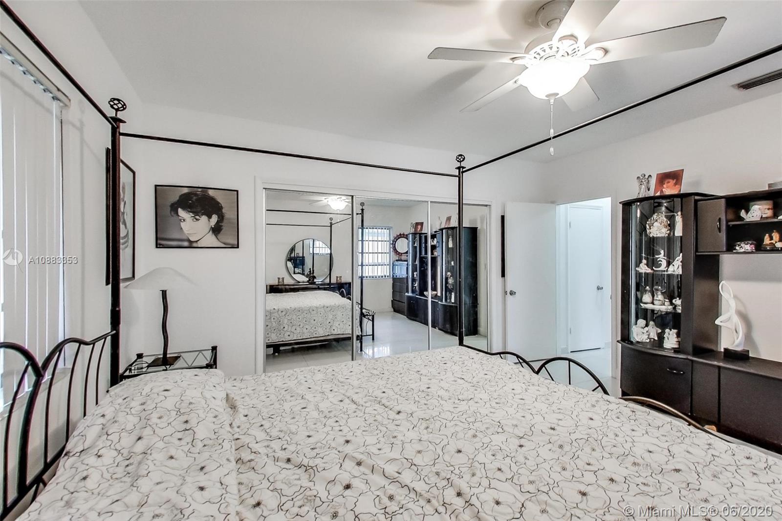63 Southwest 31st Road Miami, FL 33129 - Photo 24 of 34 a bedroom with a bed and a walk in closet