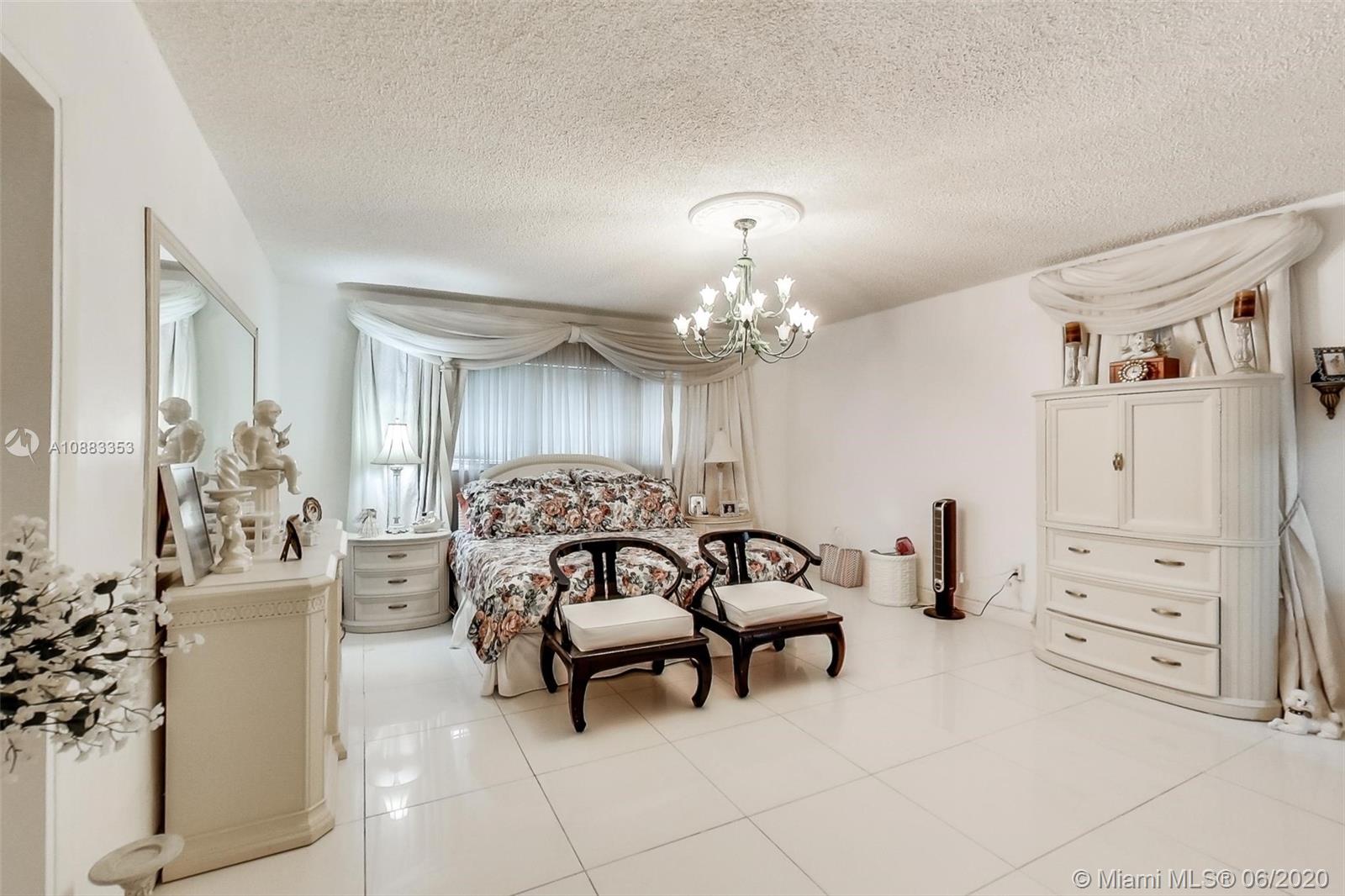 63 Southwest 31st Road Miami, FL 33129 - Photo 25 of 34 a living room with furniture and a chandelier