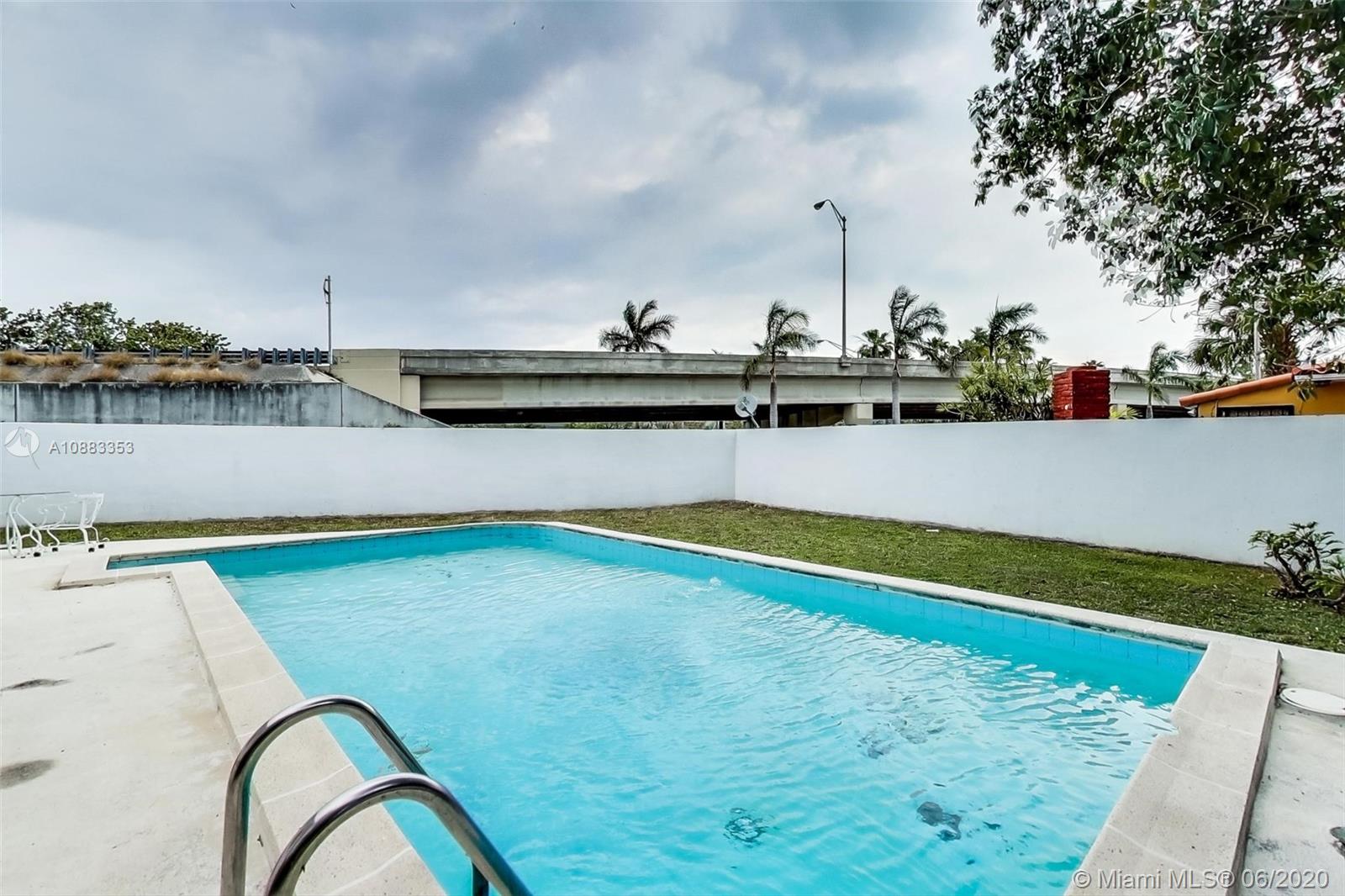 63 Southwest 31st Road Miami, FL 33129 - Photo 30 of 34 a view of a swimming pool with a yard and plants