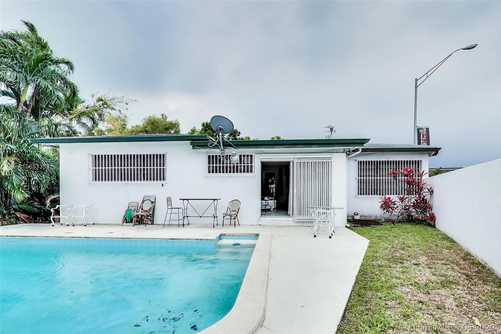 63 Southwest 31st Road Miami, FL 33129 - Photo 32 of 34 a view of a house with backyard sitting area and garden