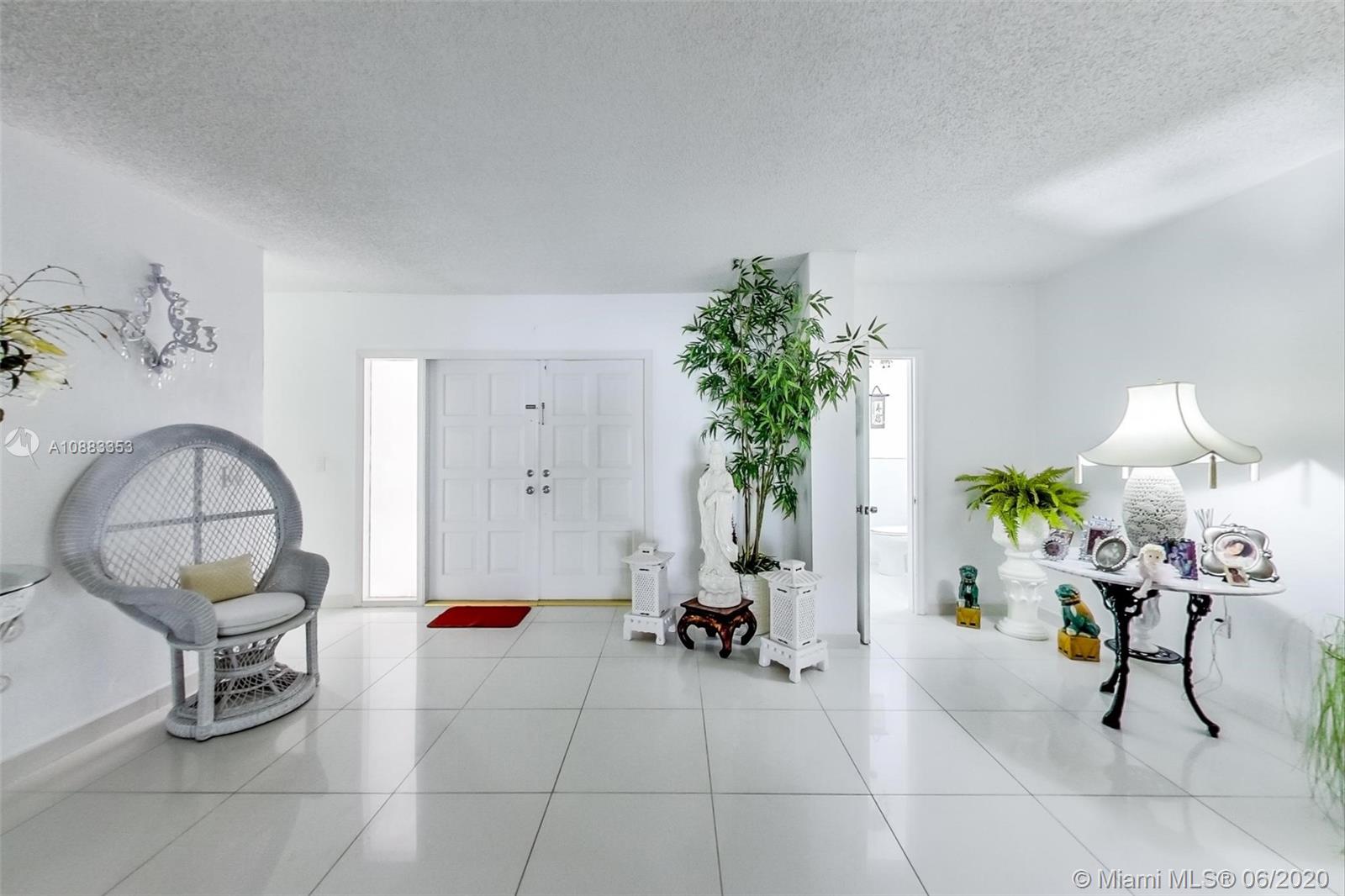 63 Southwest 31st Road Miami, FL 33129 - Photo 6 of 34 a living room with furniture a potted plant and a glass window