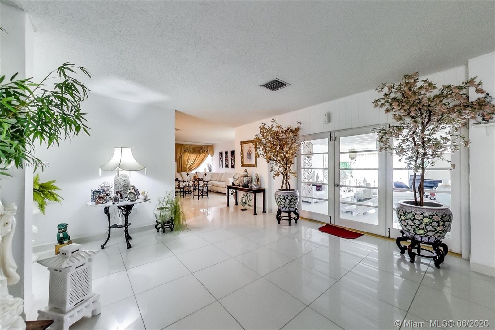 63 Southwest 31st Road Miami, FL 33129 - Photo 7 of 34 a living room filled with furniture and a chandelier