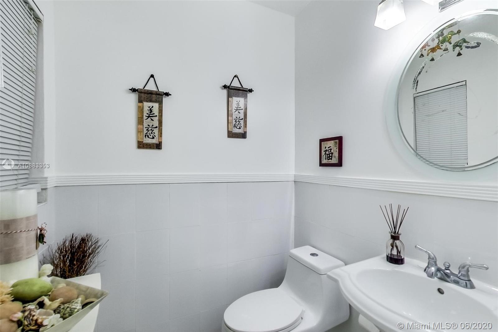 63 Southwest 31st Road Miami, FL 33129 - Photo 8 of 34 a bathroom with a toilet sink and mirror