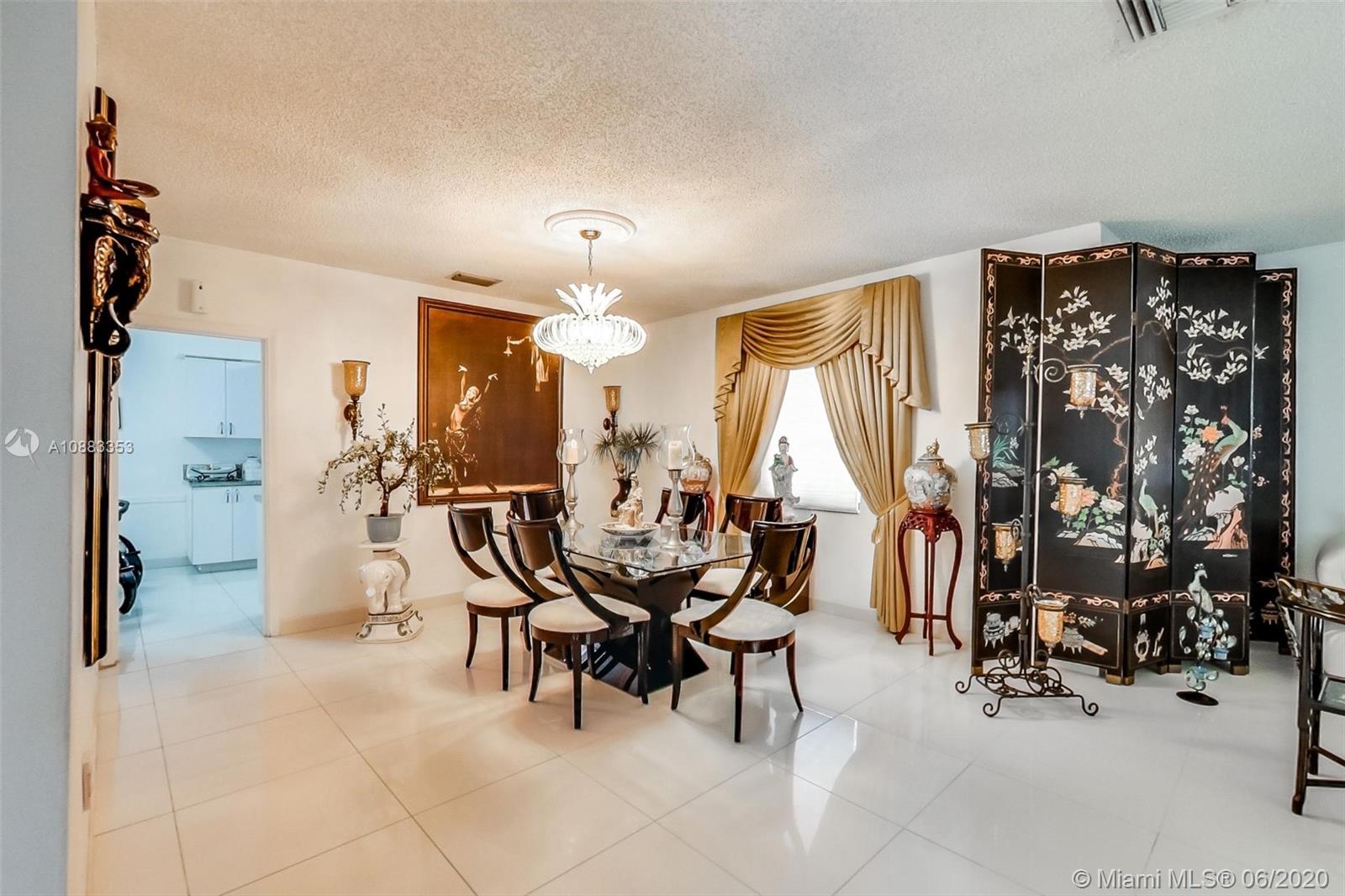 63 Southwest 31st Road Miami, FL 33129 - Photo 9 of 34 a view of a dining room with furniture and a chandelier