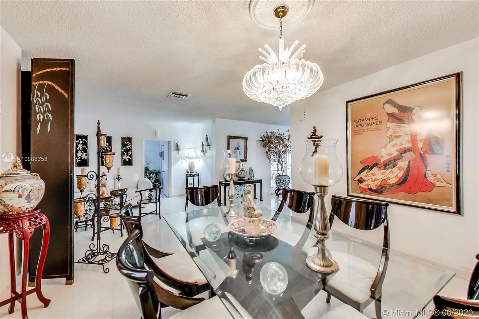 63 Southwest 31st Road Miami, FL 33129 - Photo 10 of 34 a view of a dining room with furniture wooden floor and a chandelier