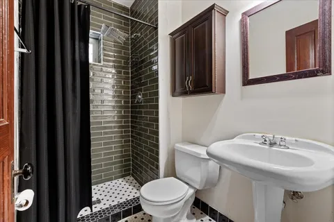 a bathroom with a sink toilet and shower