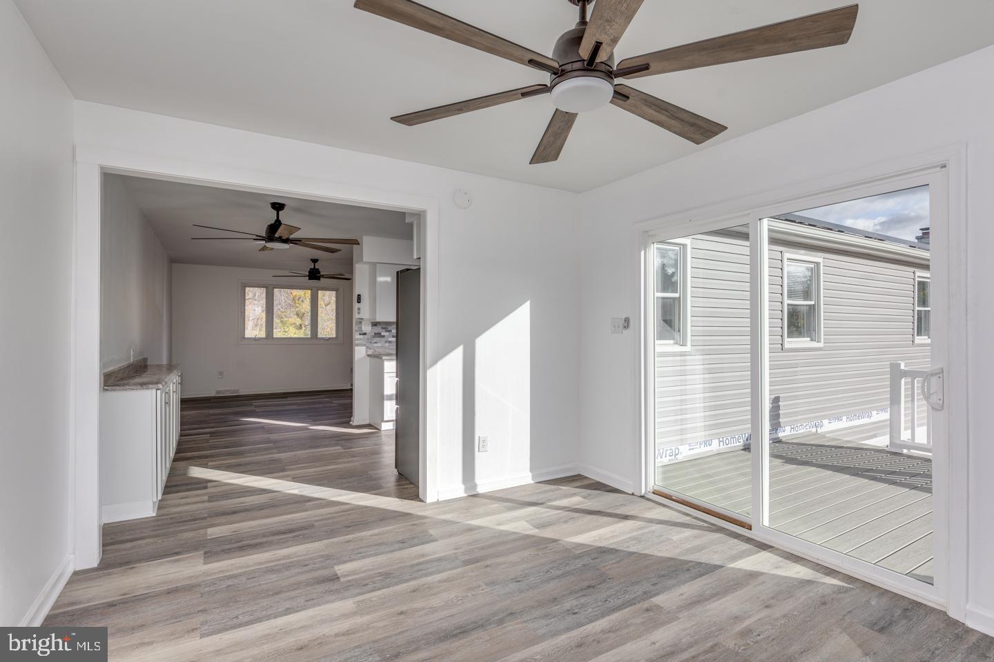 238 West Center Street Clayton, NJ 08312 - Photo 11 of 30 a view of a hallway with wooden floor and a ceiling fan