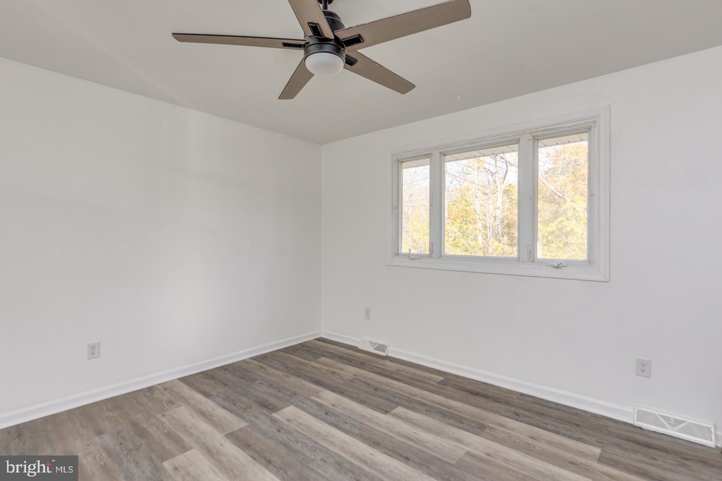238 West Center Street Clayton, NJ 08312 - Photo 3 of 30 a view of empty room with wooden floor and fan