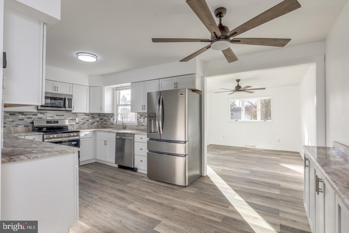 238 West Center Street Clayton, NJ 08312 - Photo 5 of 30 a kitchen with stainless steel appliances a refrigerator sink and stove