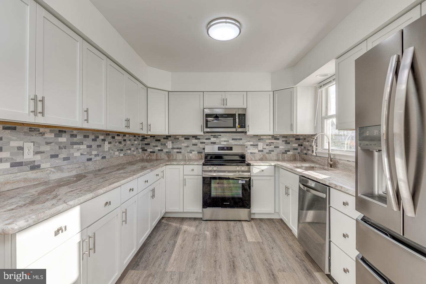238 West Center Street Clayton, NJ 08312 - Photo 6 of 30 a kitchen with stainless steel appliances granite countertop a stove top oven a sink and white cabinets