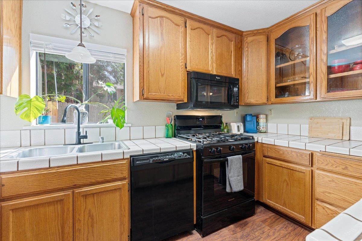 5360 Pine Ridge Drive Grizzly Flats, CA 95636 - Photo 14 of 36 a kitchen with stainless steel appliances granite countertop a stove a sink and a microwave