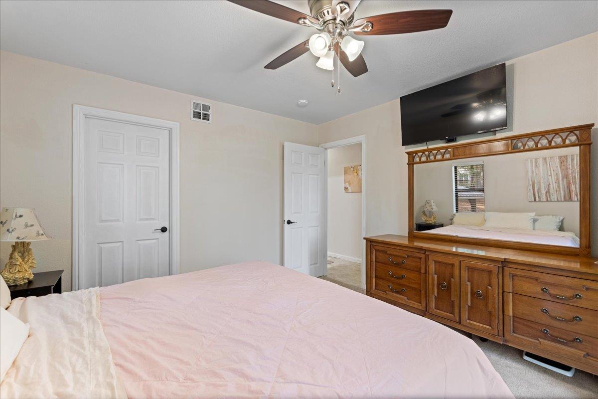 5360 Pine Ridge Drive Grizzly Flats, CA 95636 - Photo 20 of 36 a bedroom with a large bed and a flat tv screen on dresser
