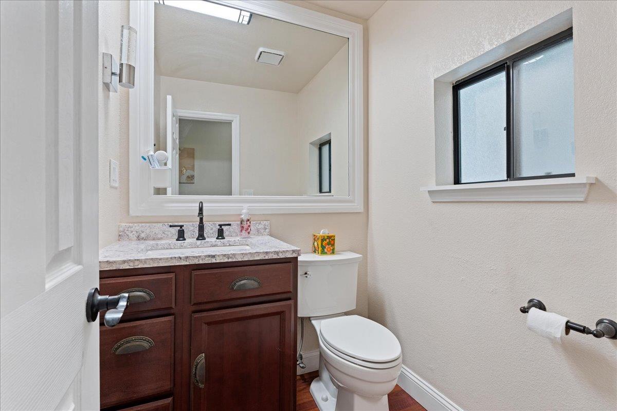 5360 Pine Ridge Drive Grizzly Flats, CA 95636 - Photo 21 of 36 a bathroom with a granite countertop toilet sink and mirror