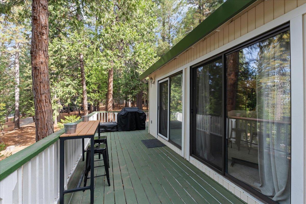 5360 Pine Ridge Drive Grizzly Flats, CA 95636 - Photo 6 of 36 a balcony with wooden floor table and chairs