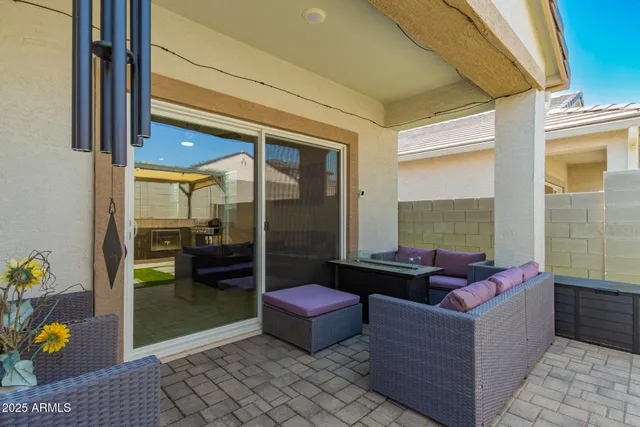 a living room with furniture and a floor to ceiling window