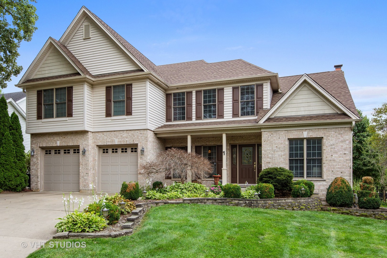 a front view of a house with a yard and garage