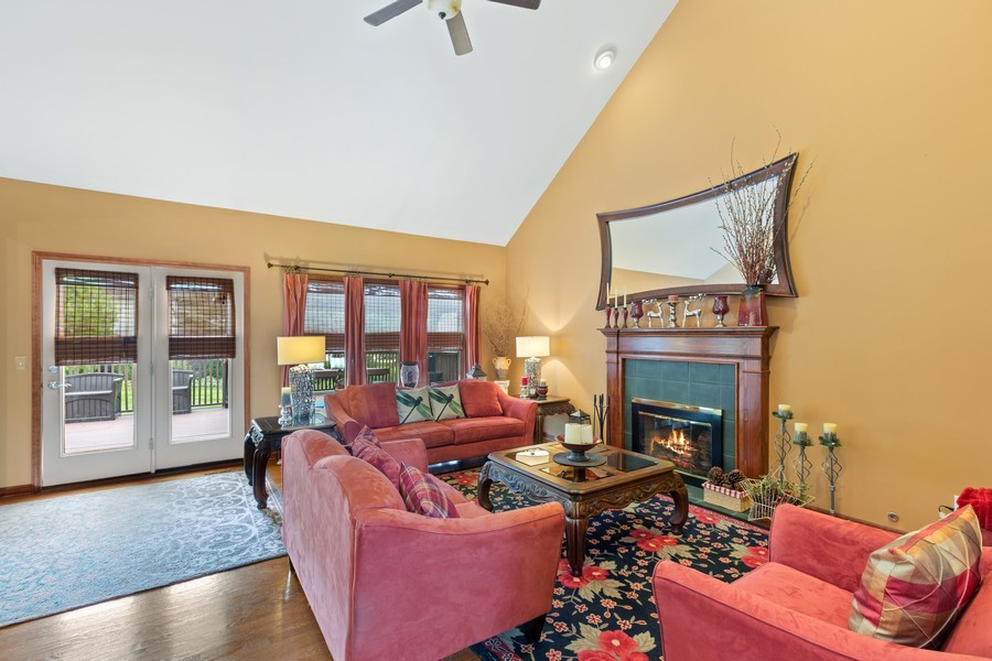 1 Walnut Lane Sugar Grove, IL 60554 - Photo 4 of 35 a living room with furniture a fireplace and a floor to ceiling window
