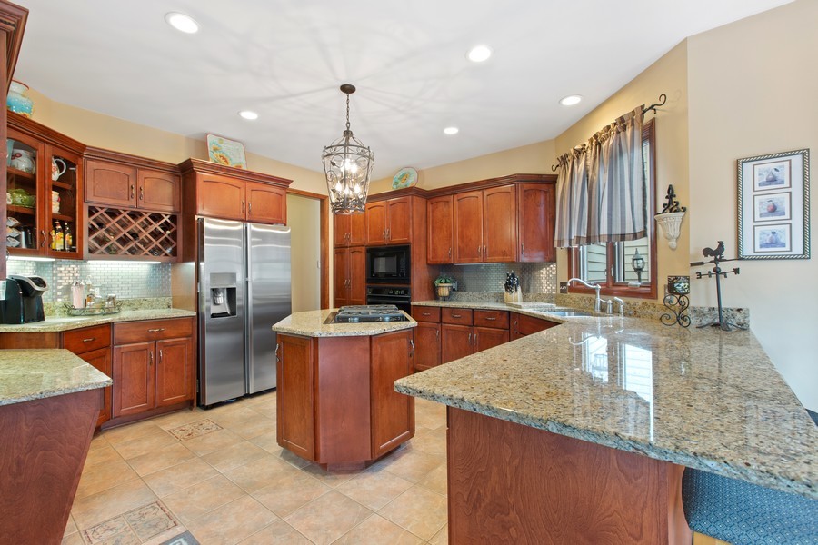1 Walnut Lane Sugar Grove, IL 60554 - Photo 7 of 35 a large kitchen with stainless steel appliances granite countertop a stove and a sink