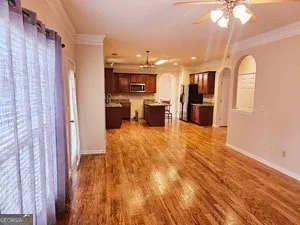 a view of living room with furniture and wooden floor