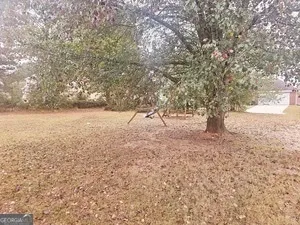 a view of open space with yard and trees