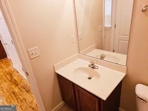 a bathroom with a sink a toilet and vanity