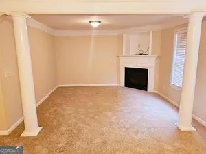 a view of empty room with fireplace