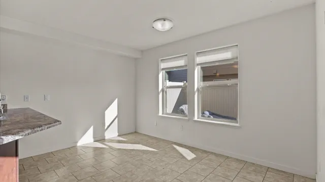 a view of a livingroom with wooden floor and a window