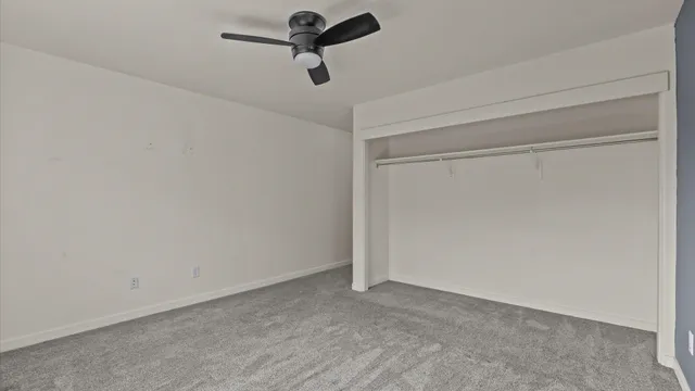 a view of a room with a ceiling fan