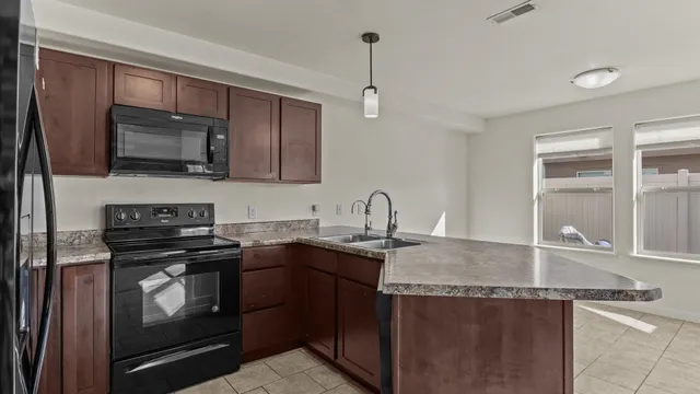 a kitchen with a sink a stove and microwave
