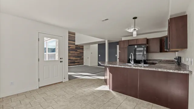 a large kitchen with cabinets and stainless steel appliances