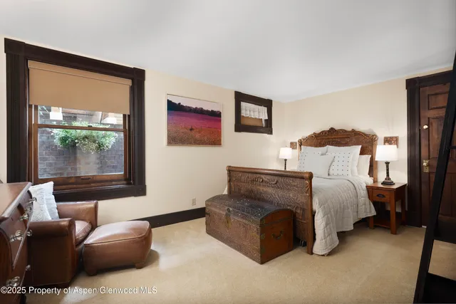 a bedroom with furniture and a window