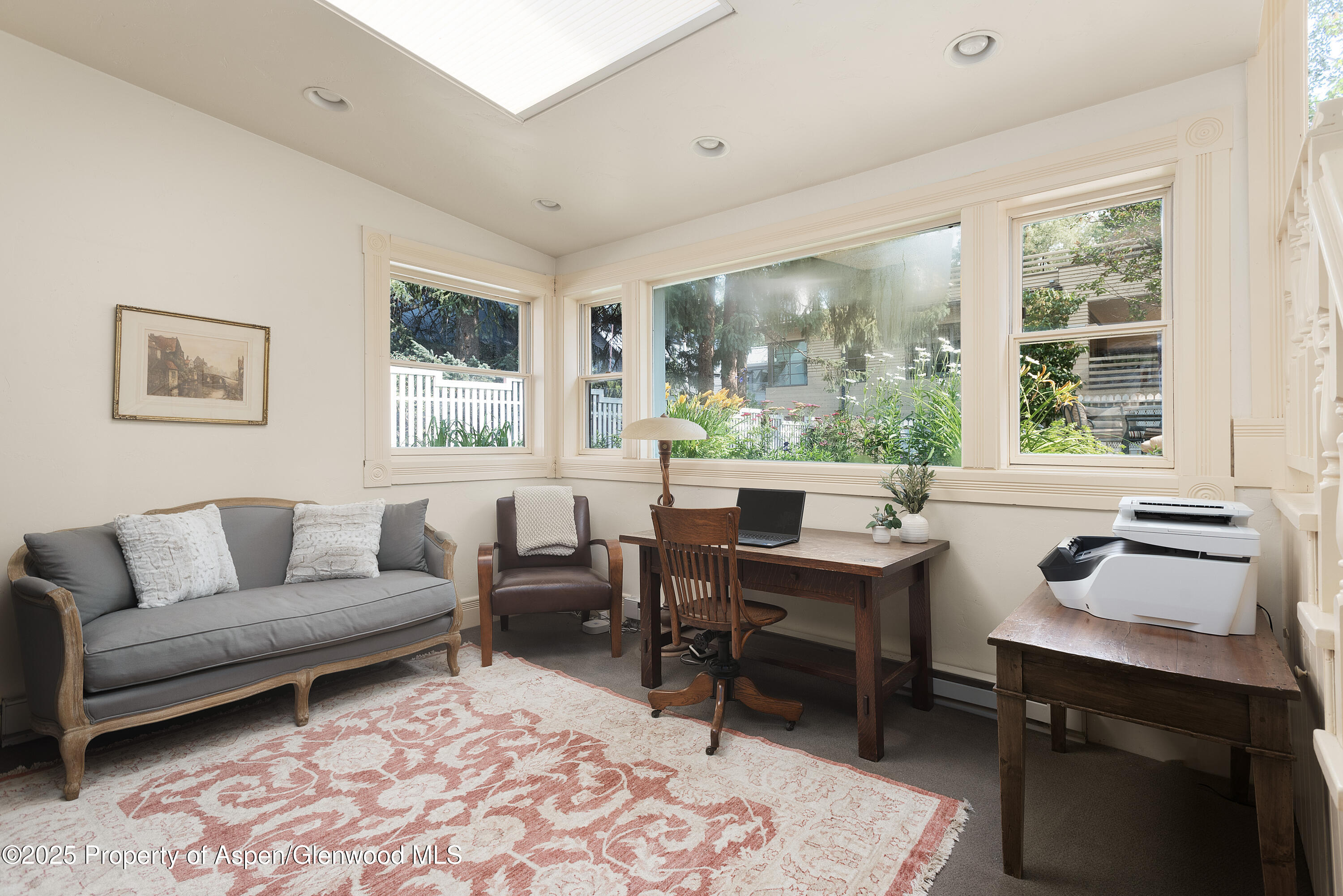 214 West Hyman Avenue Aspen, CO 81611 - Photo 17 of 21 a living room with furniture a rug and a large window