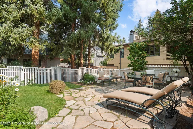 a view of a patio with table and chairs and potted plants