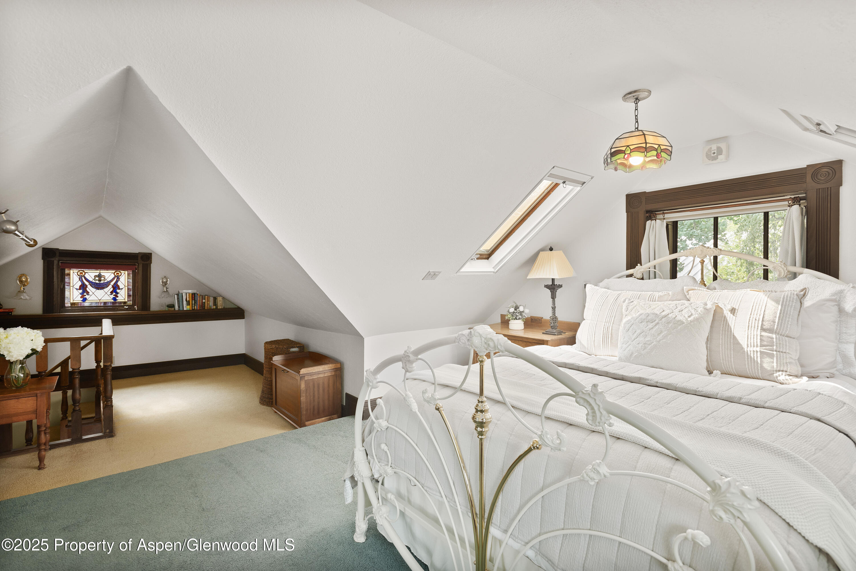 214 West Hyman Avenue Aspen, CO 81611 - Photo 6 of 21 a bedroom with a bed and a chandelier