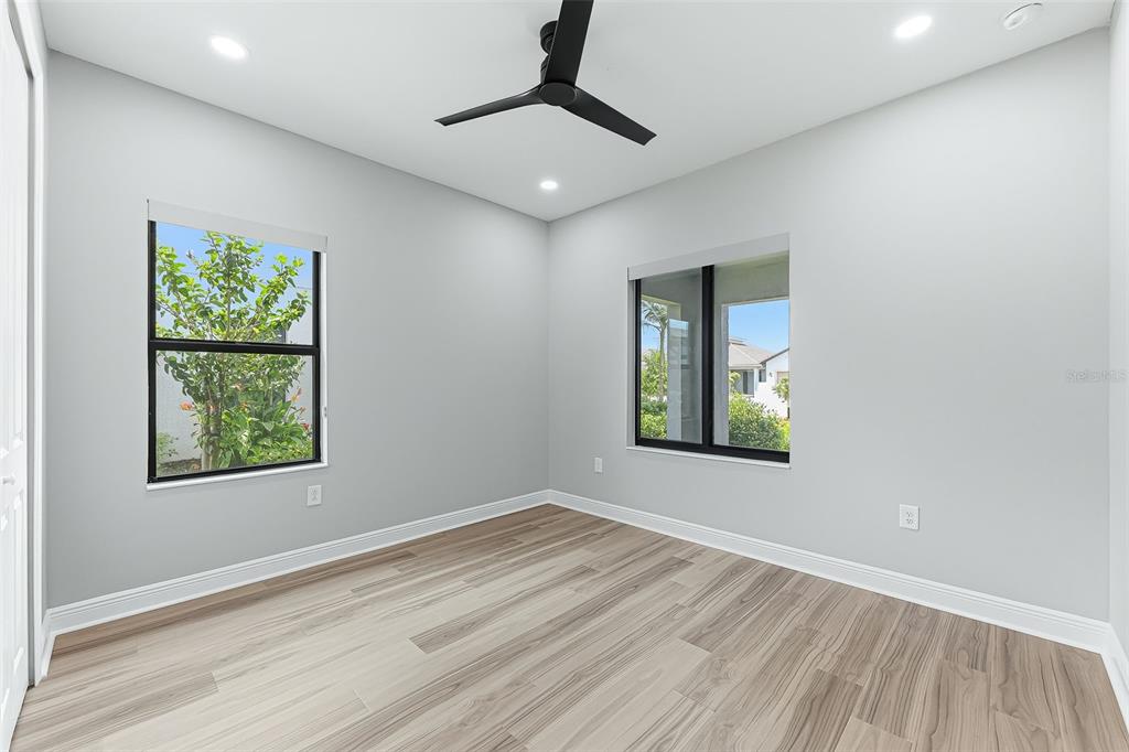 4191 Pegasus Way Naples, FL 34120 - Photo 28 of 48 wooden floor in an empty room with a window