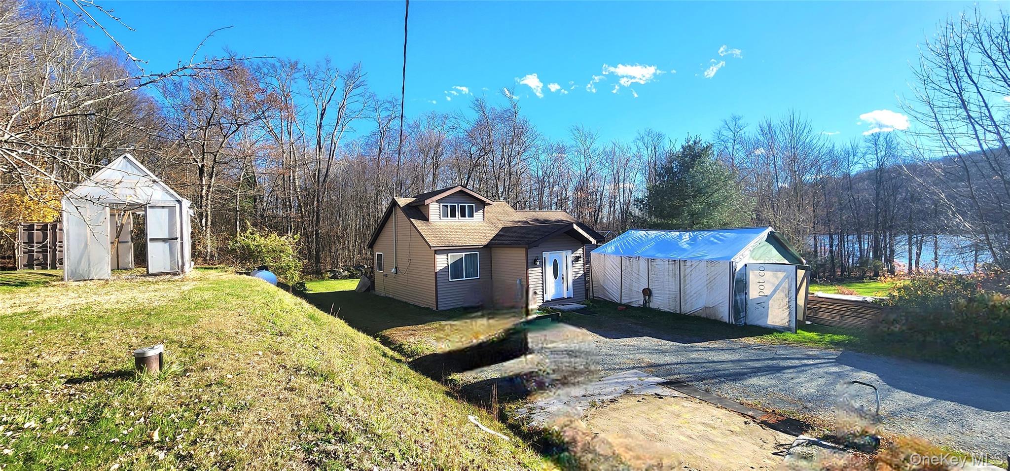 371 Kelly Bridge Road, Unit 365 Swan Lake, NY 12783 - Photo 12 of 21 a front view of a house with a yard table and chairs
