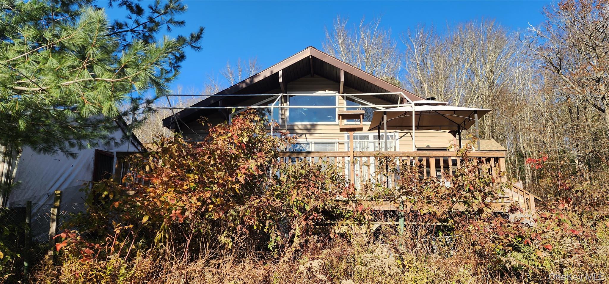 371 Kelly Bridge Road, Unit 365 Swan Lake, NY 12783 - Photo 2 of 21 a front view of a house with a yard