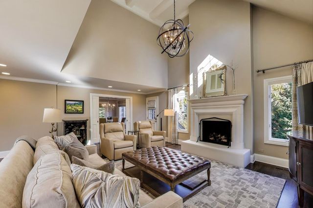 a living room with furniture a fireplace and window