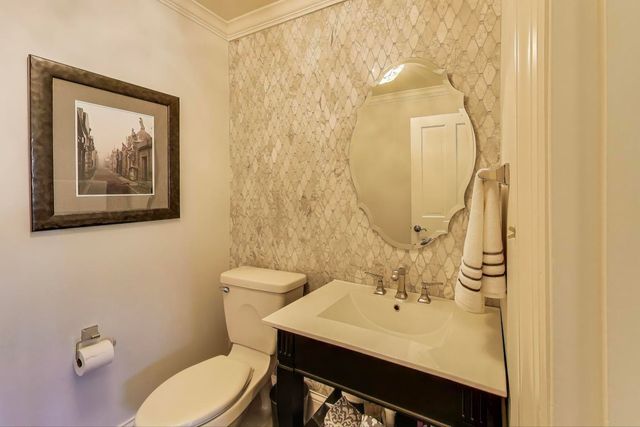 a bathroom with a sink mirror and toilet