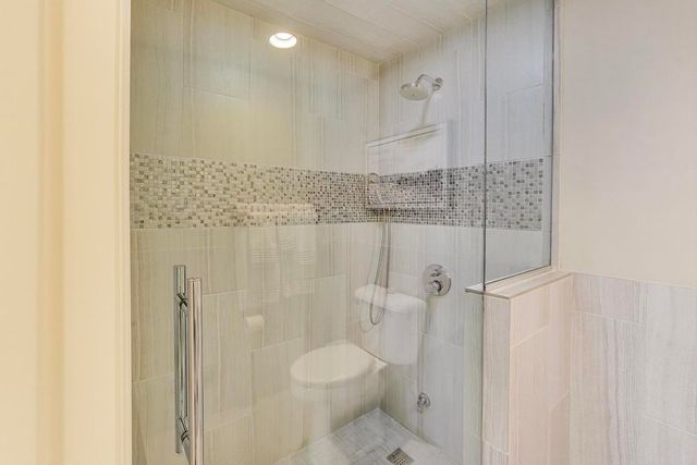 a view of staircase with railing and a chandelier