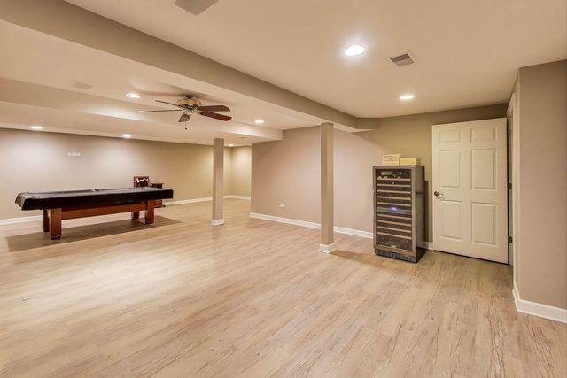 a view of hallway with stairs and wooden floor