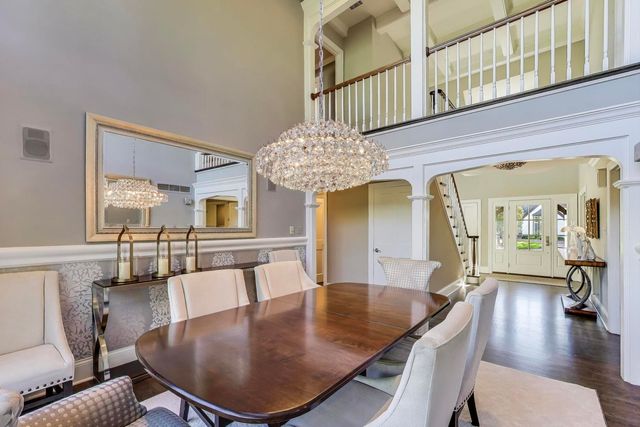 a dining room with furniture and wooden floor