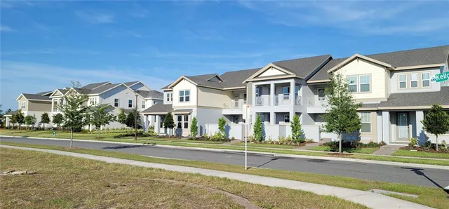 an aerial view of a residential apartment building with a yard